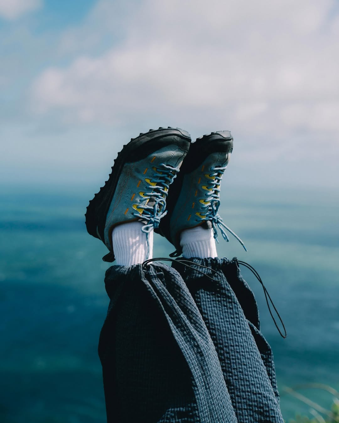 GX-10 STORM boots, ripstop nylon upper and lugged outsole, worn on a coastal cliff